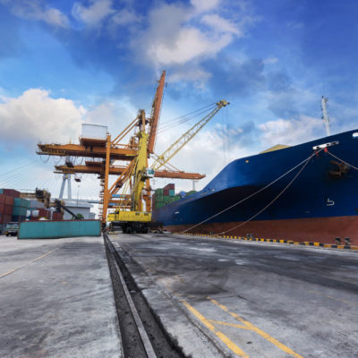 Industrial Container Cargo Freight Ship With Working Crane Bridg Industrial Container Cargo freight ship with working crane bridge in shipyard with truck